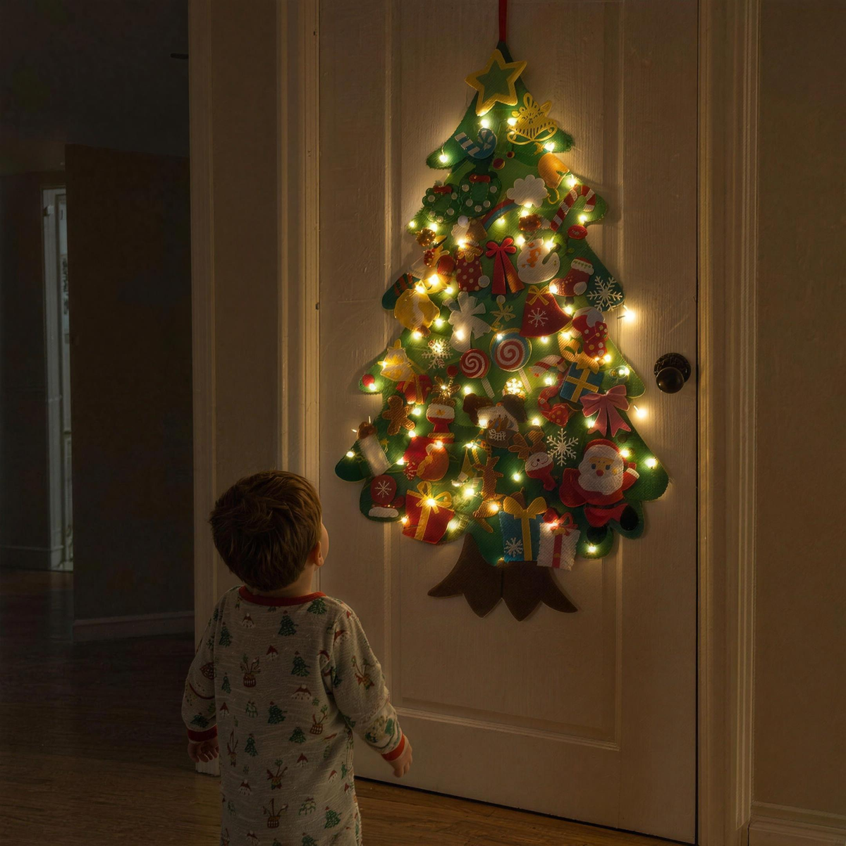 TinselTots felt tree glowing on a bedroom door at night