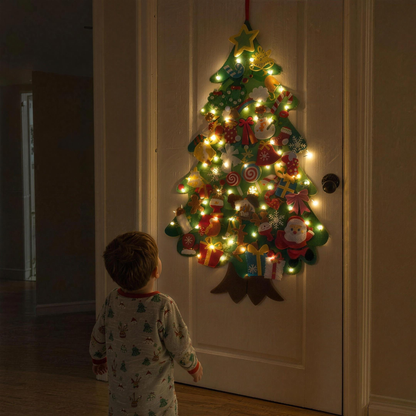 TinselTots felt tree glowing on a bedroom door at night